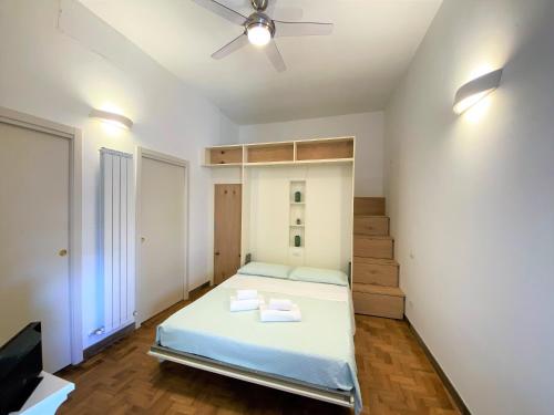 a bedroom with a bed and a ceiling fan at CAMPOREGIO 31- In Centro con Vista sul Duomo in Siena
