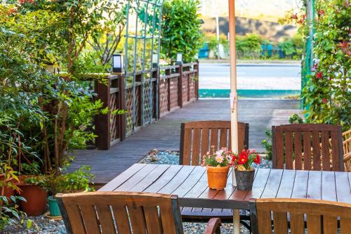 a wooden table with two potted plants on it at Four Seasons Pension in Suncheon