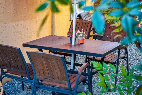 a wooden table and chairs with flowers on it at Four Seasons Pension in Suncheon