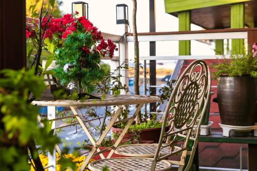 a table and chairs with flowers on a balcony at Four Seasons Pension in Suncheon