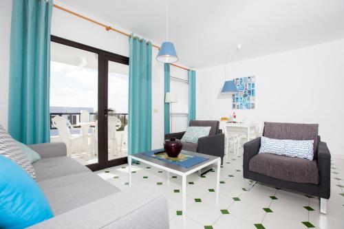 a living room with a couch and chairs and a table at Costa Luz Apartment PDC with Sea Views in Tías