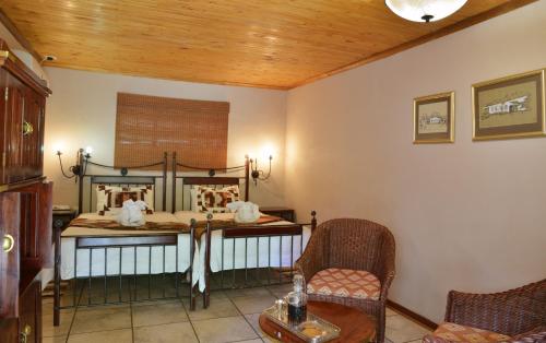 a bedroom with a bed and a table and chairs at Kasane Self Catering in Kasane