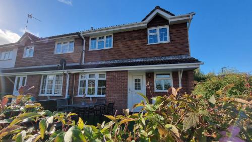 a brown brick house with a white door at Haxby House by Switchback Stays in Cardiff