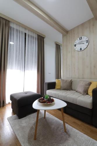 a living room with a couch and a table at All Seasons Residence in Zlatibor