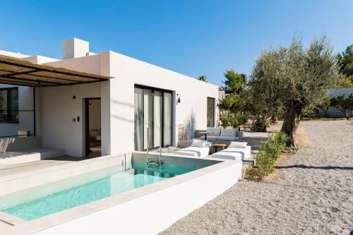 a villa with a swimming pool in front of a house at Lindos Aqua Terra in Líndos