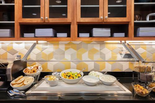 a kitchen with bowls of food on a counter at Hyatt Place Reno/Tahoe Airport in Reno