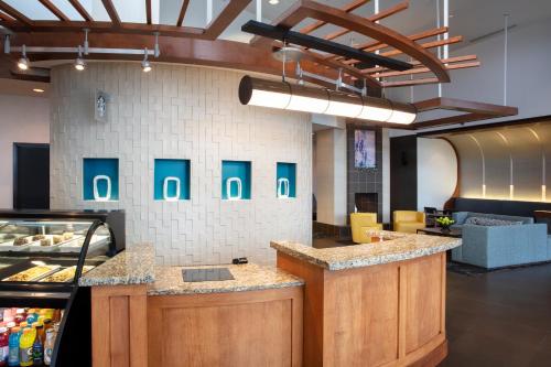 a kitchen with a counter in a restaurant at Hyatt Place Reno/Tahoe Airport in Reno