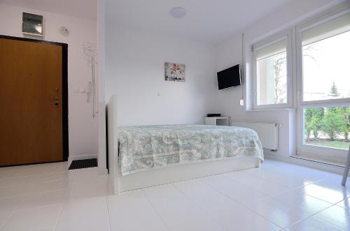 Katil atau katil-katil dalam bilik di Victus Apartamenty, Apartament White Positano