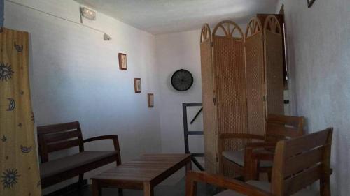 a room with tables and chairs and a clock on a wall at Manxalo in Sant Mateu