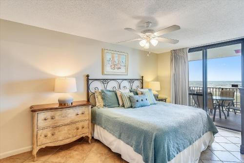 a bedroom with a bed and a view of the ocean at Phoenix 7 215 in Orange Beach