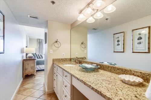 a bathroom with a sink and a large mirror at Phoenix 7 215 in Orange Beach