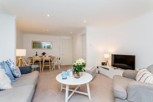 a living room with a couch and a table at 3BR Central Patio Home with Parking in Brighton & Hove