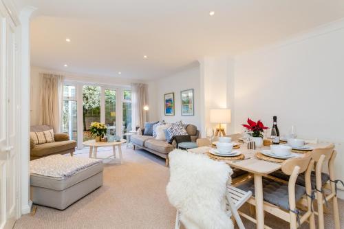 a living room with a table and a couch at 3BR Central Patio Home with Parking in Brighton & Hove