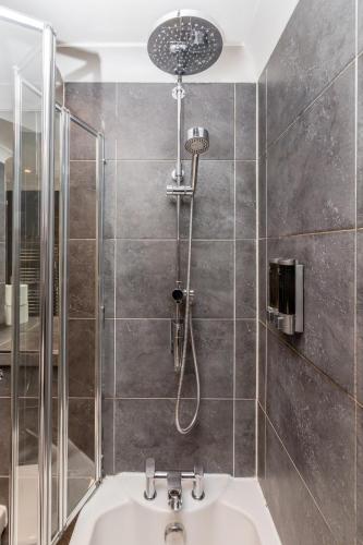 a bathroom with a shower and a sink at 3BR Central Patio Home with Parking in Brighton & Hove