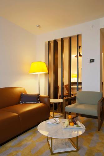 a living room with a couch and a table at Crowne Plaza Belgrade by IHG in Belgrade
