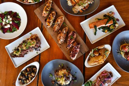 a wooden table with plates of food on it at Ledges Hotel in Hawley