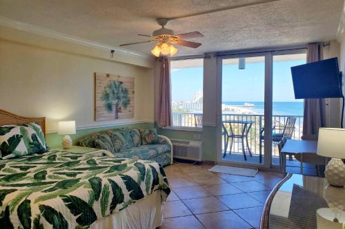 a bedroom with a bed and a view of the ocean at Harbour Beach Resort Unit #818 in Daytona Beach