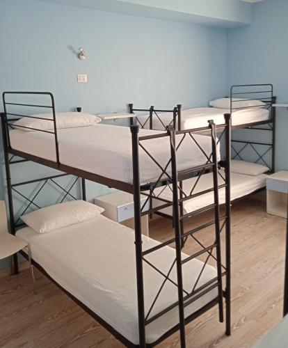 a group of bunk beds in a room at Ostello La Sosta in Contrada Anselmi