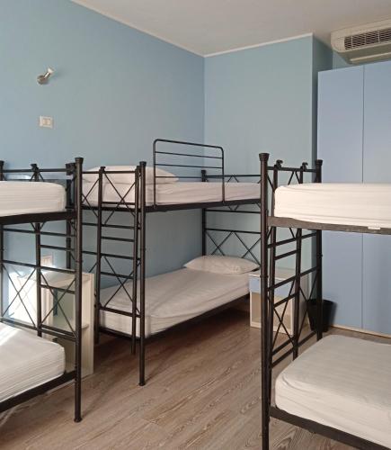 a group of bunk beds in a room at Ostello La Sosta in Contrada Anselmi