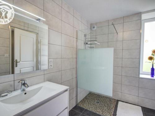 a bathroom with a sink and a shower with a mirror at Gîte Saint-Didier-sur-Rochefort, 7 pièces, 12 personnes - FR-1-496-18 in Saint-Didier-sur-Rochefort