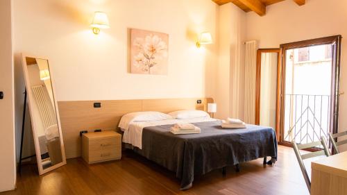 a bedroom with a bed with two towels on it at Antiche Mura - Italian Homing in Verona