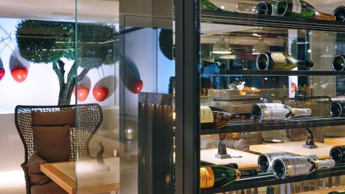 a display case of wine bottles in a store at Mec Paestum Hotel in Paestum