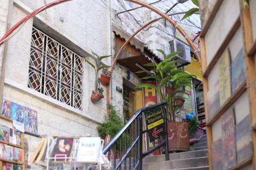 a building with stairs and plants on the side of it at Riviera Hotel in Amman