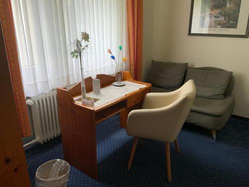 a living room with a table and a couch at DAS LOFT Hotel Hölsterloh in Brilon