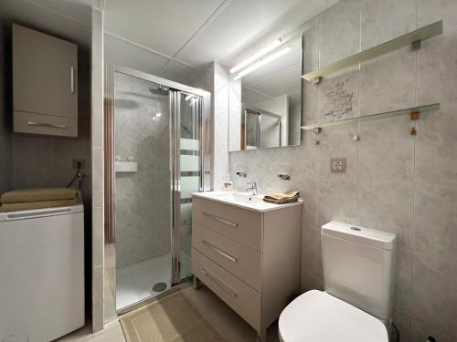a bathroom with a toilet and a sink and a shower at Tamarán 311 in Playa del Ingles