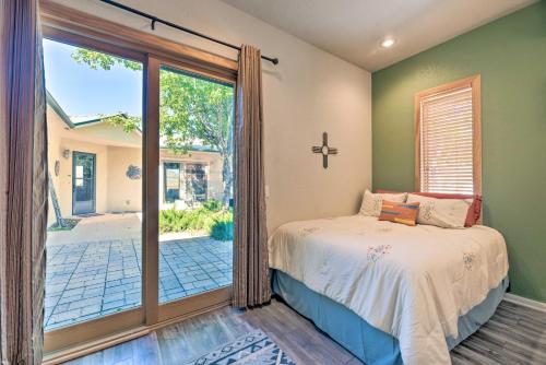 a bedroom with a bed and a sliding glass door at Docs Retreat in Ruidoso Downs with Mtn Views in Ruidoso Downs
