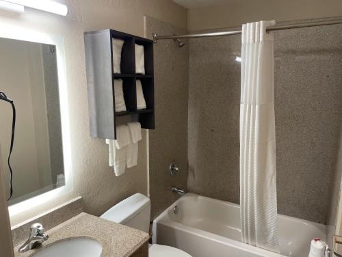 a bathroom with a toilet and a sink and a shower at Super 8 by Wyndham San Antonio Downtown NE in San Antonio