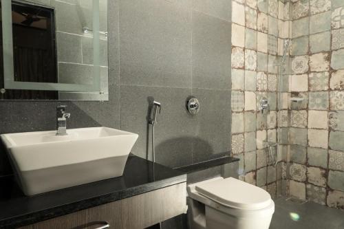 a bathroom with a sink and a toilet at Sao Domingos in Cavelossim