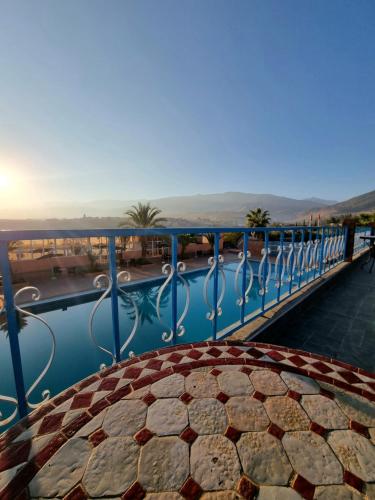 a balcony with a view of a swimming pool at L'oliveraie D'amizmiz in Amizmiz