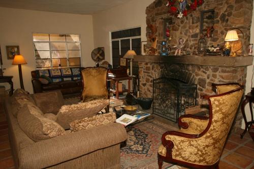 a living room with a couch and a fireplace at Spirit Tree Inn B&B in Patagonia