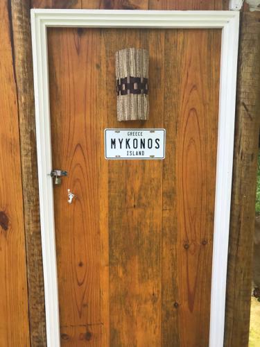 a sign on a door that says mykoons farm at Cabana do Mar in Angra dos Reis