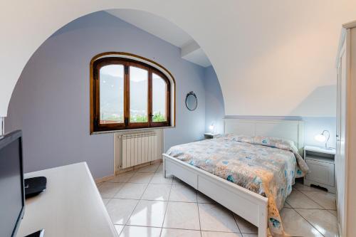 een slaapkamer met een bed en een raam bij Casa Grillo in Tramonti