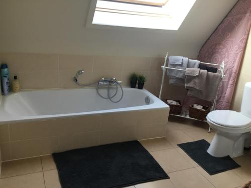 ニーウポールトにあるBrise De Merのバスルーム(白いバスタブ、トイレ付)