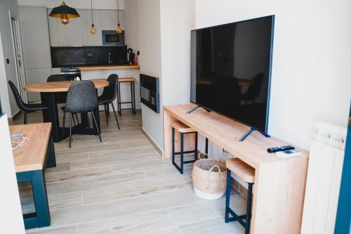 a living room with a large flat screen tv at Apartamentos Turia Teruel in Teruel