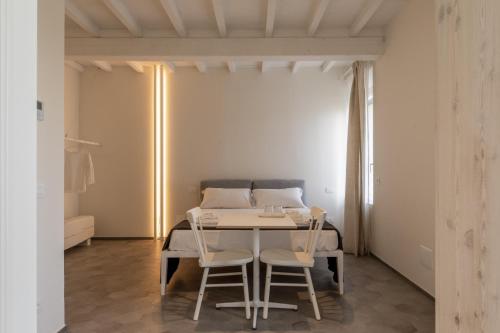 a dining room with a table and two chairs at La Pervinca - Ospitalità, Natura, Cura in Guastalla