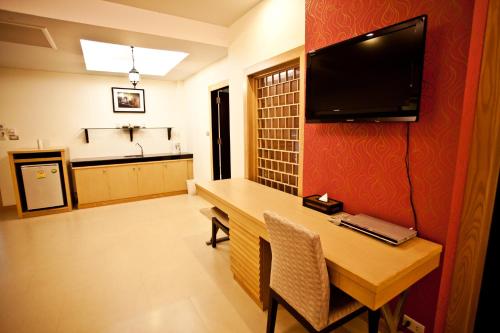 a kitchen with a television and a sink at Krabi Tipa Resort - SHA EXTRA PLUS in Ao Nang Beach
