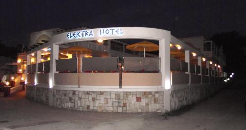 a building with an outdoor restaurant at night at Elektra Beach Hotel in Kalamaki Chanion