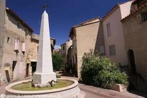 a large white monument in the middle of a street at Magnifique appartement neuf au centre d'Istres in Istres