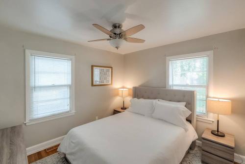 a bedroom with a white bed and a ceiling fan at Charming 2 BR 1 BA with outdoor patio and grill close to downtown in Lexington