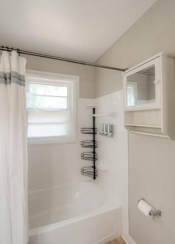 a bathroom with a shower curtain and a window at Charming 2 BR 1 BA with outdoor patio and grill close to downtown in Lexington