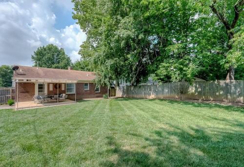 a yard with a house and a fence at Charming 2 BR 1 BA with outdoor patio and grill close to downtown in Lexington