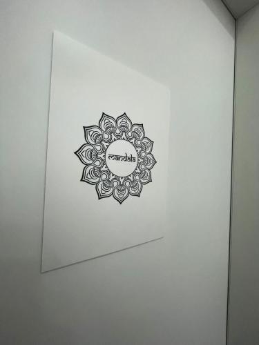 a drawing of a mandala on a white wall at B&B Sweet Sleep in Naples