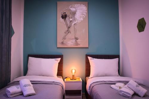 a room with two beds with a flamingo on the wall at Apartments Experience Zagreb in Zagreb