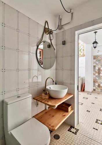 a bathroom with a sink and a toilet and a mirror at Algarve house, sun, terrace, views and barbecue in Silves