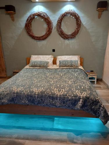 a bedroom with a bed with two mirrors on the wall at Alegria rustica in Envendos