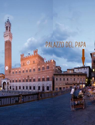 a view of a large building with a clock tower at Palazzo del Papa in Siena